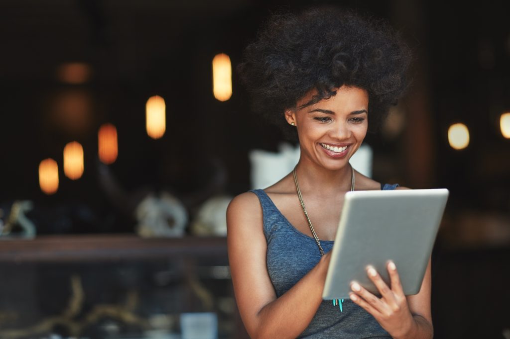 Her online orders are growing. Shot of a young woman using a digital tablet in a cafe.